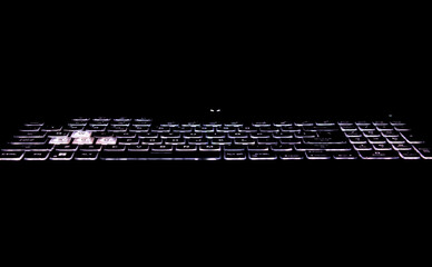  laptop keyboard with black background and white light