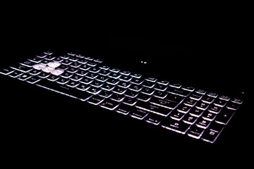 glowing laptop keyboard with black background