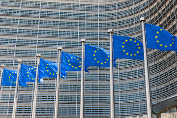 Fluttering European Union flags in a row in Brussels, Belgium. Close up