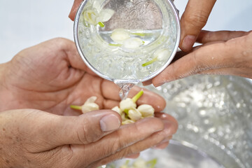 Pour water on the hands of revered elders and ask for blessing.