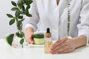 Cosmetics with chemical flasks and a flower