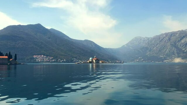 Slow motion view of islands in the Bay of Kotor. The Island of Saint George and Our Lady of the Rocks near the town of Perast. Adriatic Sea. Perast, Montenegro. Europe.