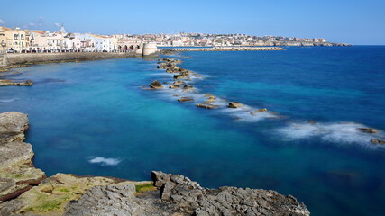 The Eastern rocky coast of Ortigia Island, Syracuse, Sicily, Italy, with clear and colorful water © Christophe Cappelli