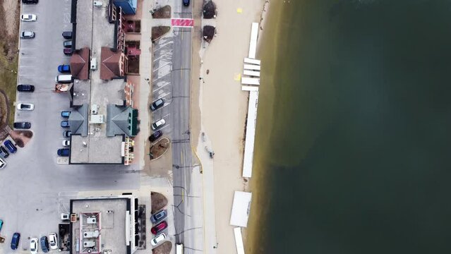 flyover of a small beach town in the midwest during winter (Pewaukee, WI)