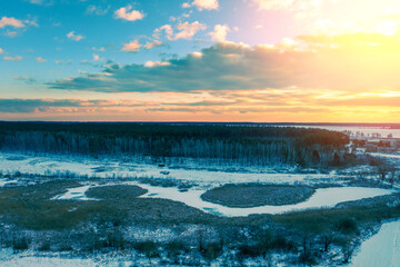 Rural landscape in winter. Sunset in the countryside. Drone view