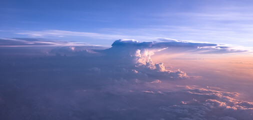 An aerial shot above beautiful sunset, sunrise clouds. Sunset above the clouds from airplane...