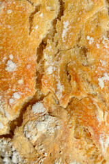 Detail of cracked crust of homemade baked sourdough bread