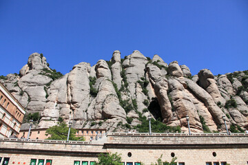 famous Catholic monastery of Montserrat on the background of rocks.  Catalonia, Spain. - obrazy, fototapety, plakaty