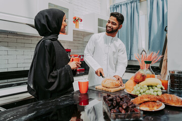 Happy middle eastern couple wearing traditiona larab clothing at home