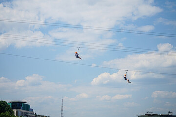 People ride on special seats for bungee jumping