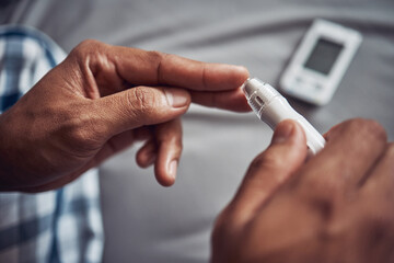 Person, hand and blood sugar with finger in home for diabetes to monitor insulin, glucometer or...