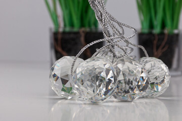 a group of cut glass balls lying on a white surface with real shadows