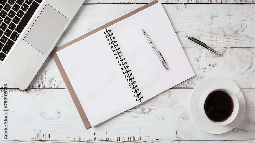 Poster blank notebook with pen are on top of wood office desk table with laptop computer cup of coffee and 