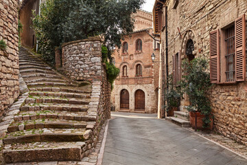 Corciano, Perugia, Umbria, Italy: picturesque corner in the old town with  an ancient staircase and the 15th century building Palazzo del Capitano - 789108971