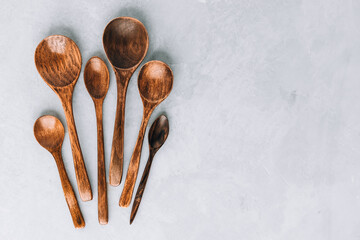 Wooden spoons. Wooden spoons on gray stone background, kitchen concept.