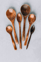 Wooden spoons. Wooden spoons on gray stone background, kitchen concept.