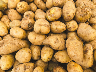 Pile of fresh potatoes on sale in vegetable stand display at supermarket show organic food, vegetarian food, Healthy food. Heap of potato sale in market use for texture and background.