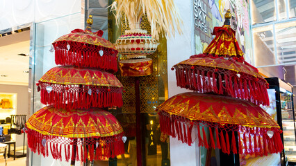 Bali March 2024 - Balinese red cerimonial umbrellas at the international airport in Bali, Indonesia.