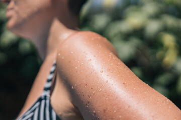 Wet arm of a tanned woman, concept of prevention and care of the skin and exposure to the sun's rays