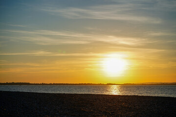 Sun set over a sandy beach and ocean in England