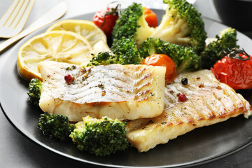 Tasty cod cooked with vegetables served on grey table, closeup