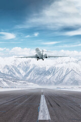 Business jet take off airport runway at winter on the background of high scenic snow capped mountains - obrazy, fototapety, plakaty