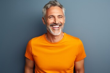 Portrait of a grinning man in his 50s donning a trendy cropped top isolated on solid color backdrop - obrazy, fototapety, plakaty
