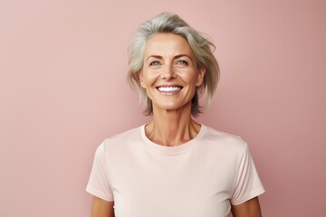 Portrait of a grinning woman in her 40s donning a classy polo shirt on solid pastel color wall