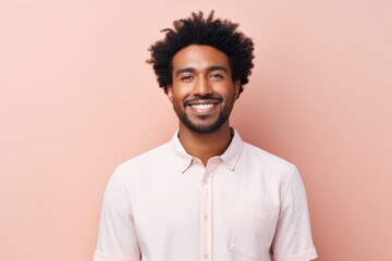 Portrait of a satisfied afro-american man in his 20s wearing a simple cotton shirt while standing...