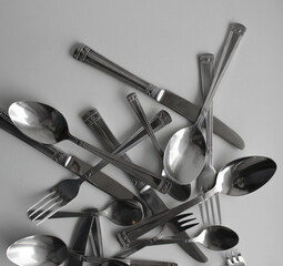 Mix Of Silvery Forks, Knives And Spoons For Eating Closeup View. Photo For Cutlery Concept...