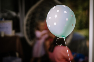 Valmiera, Latvia- July 29, 2023 - A polka-dotted balloon is in focus with a blurred figure in the...