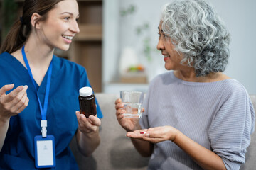 medicine, healthcare and people concept.  female therapist gives medication advice to an elderly patient.