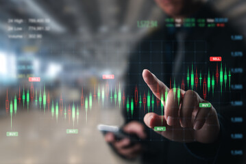 Businessperson pointing to stock market buy and sell signals on a digital screen. - 789142385