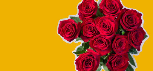 A bouquet of red roses on a yellow background and space for text material.