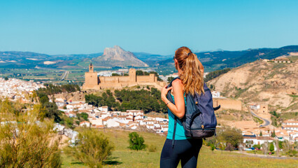 Woman looking at Castle fortress Real Colegiata de Santa Maria La Mayor, Antequera, Spain