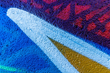 Colorful beautiful background of urban spray drawing graffiti on city wall. Bright vivid pattern of  modern art for wallpaper and design.