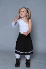 Beaming young girl enjoys a playful dance, her spirit as lively as her hairstyle. Encapsulates the...
