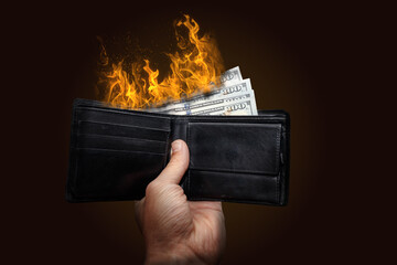 Burning dollar banknotes in wallet showing concept of inflation or wasting money