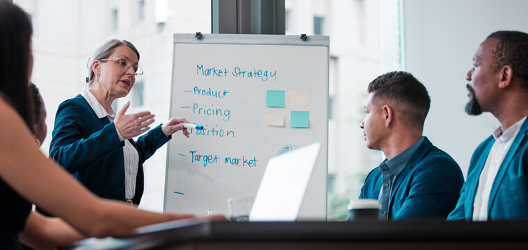 Presentation, training and mature woman, boardroom and meeting for strategy, marketing and target for sales. Speaker, boss and employees in office, listen and workshop in company, CEO and white board