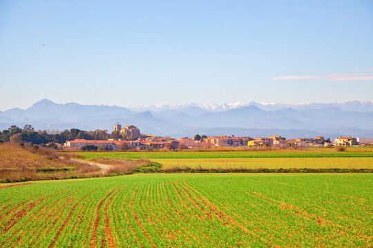 Peralada, medieval Catalan town with the Pyrenees in the background..