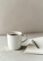 A Cup of Coffee and a Notebook on a Bed