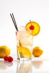 Refreshing classic Tom Collins or Whiskey sour cocktail with a maraschino cherry and lemon slice on white background