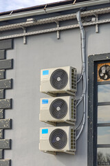 Three Split Air Conditioners System Condenser Units at Industrial Building Wall