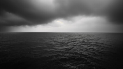 Black and white photography of the rainy ocean, dark with clouds. Landscapes photography