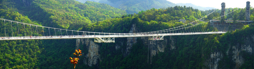 The glass bridge of Zhangjiajie, China This glass bridge serves as a way to connect the two cliffs...