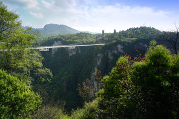 dam in the mountains , The glass bridge of Zhangjiajie, China This glass bridge serves as a way to connect the two cliffs together with beautiful scenery.