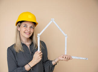 woman, architect, technician, builder, polisher with yellow safety hat and yellow folding rule in front of brown background