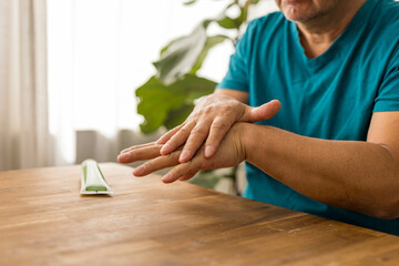 skin care, hands smeared with cream on dark background
