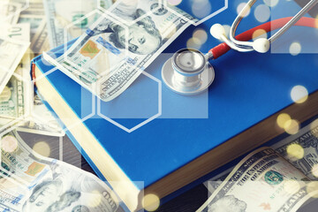Close up red stethoscope on the US dollar banknote on wooden table. Health check or money and financial concept
