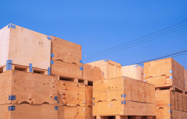 Pile of many the old big wooden crates for sale and reusable with recycling against blue sky background